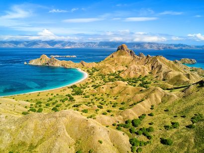 A breathtaking scene of Komodo Island within Komodo National Park, highlighting its dramatic landscapes and pristine waters, ideal for adventure-filled tours and close encounters with unique wildlife.